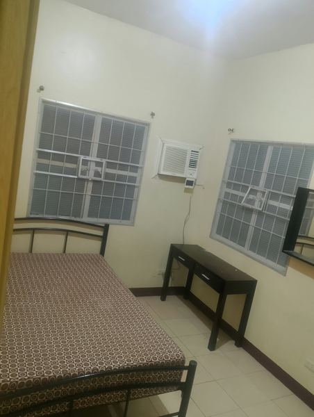 Bedroom with bed, desk and aircon